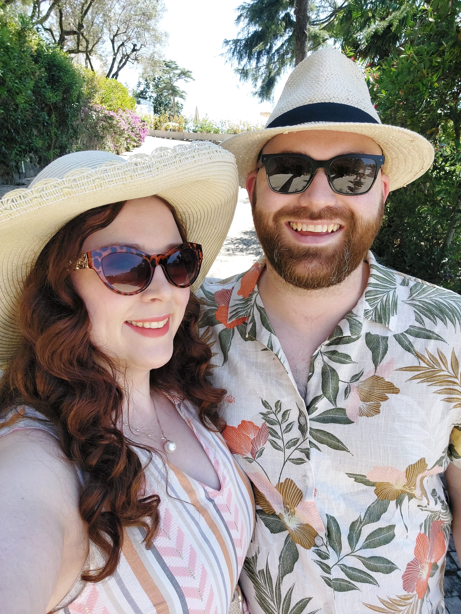 Laura & Bob wearing hats and sunglasses in the sun